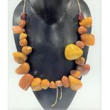 A string of irregular shaped butterscotch amber beads, weight 117.3g approx.