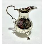 A Victorian silver cream jug, foliate embossed, maker Henry Holland, London 1853, height 9.5cm,