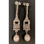 An exquisite pair of Art Deco style platinum diamond and pearl drop earrings, the stud back with a