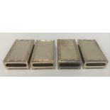 An Edwardian set of four silver matchbox holders, the tops with reeded and ribbon edge and each