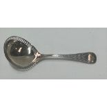 An Edwardian Britannia standard silver caddy spoon, the handle with bright cut decoration, the