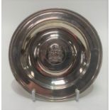 A George V silver card tray, the rim with cast continuous star decoration, the centre well with