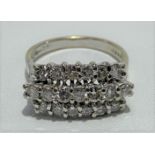A modern 18ct white gold diamond set nineteen stone ring, the diamonds set in three lines, the
