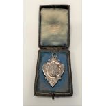 A cased Victorian silver watch fob medallion, maker WC JL, Birmingham 1976, engraved dedication to