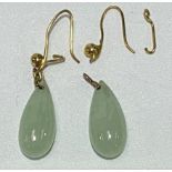A pair of gold mounted green jade drop earrings, length of jade 18mm, weight 4.4g approx.
