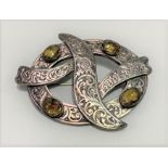 A Scottish silver brooch, foliate scroll engraved and inset with four oval cut citrines, 65 x