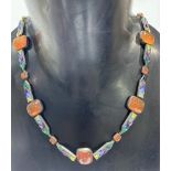 A stylish Art Deco silver hard stone necklace, the large oblong orange stone cabochons between
