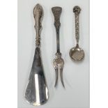 A George V silver handled shoe horn, Birmingham 1914; together with a white metal spoon with Greek