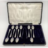 An incomplete cased set of nine George VI silver teaspoons and sugar tongs in Old English pattern,