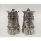 Pair of white metal pepperettes in the form of cylindrical castellated towers and with mortars,