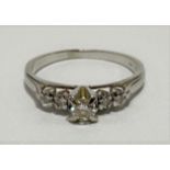 An 18ct white gold diamond set five stone ring, the central diamond of 0.20ct spread approx, flanked