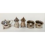 A George V silver five piece cruet set with pie crust rim and each on triple outswept feet, maker