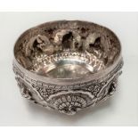 Indian white metal bowl embossed in high relief with a peacock and deities within reserves, the base