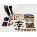 Bag of militaria items, including two RAF cloth badges, shoulder epaulettes RAF brass buttons,
