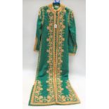 A Syrian green tunic with gold thread embroidery, label for George Dabdoub, Bzourieh Azem Palace