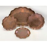 An Arts & Crafts Hayle copper circular tray with wavy rim, with planished and incised decoration,