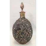 A dimple pinch whisky bottle with Chinese silver plate on copper embossed overlay, decorated with