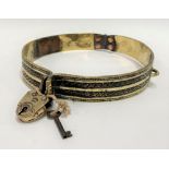 A 19th century brass dog collar with padlock clasp, diameter 21cm.