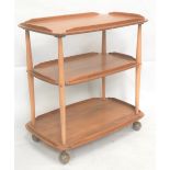 An Ercol pale elm three tier trolley with casters, width 71cm.