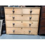 A Victorian stripped pine straight front chest of drawers, the bamboo moulded edged top over two