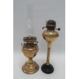 Two brass oil lamps, one with white opaque glass shade