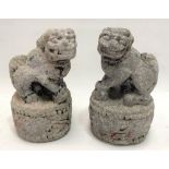 Pair of antique Chinese carved stone Buddhistic lions upon circular base, remnants of original