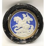 A circular glazed plaster wall plaque depicting Saint George and The Dragon, diameter 49cm.