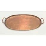 A John Pearson style Arts & Crafts copper, twin handled, planished oval tray, width 57cm.