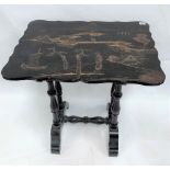 A Victorian black lacquered side table, the serpentine rectangular top decorated with a landscape
