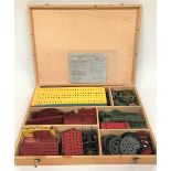 Meccano pine hinge-lidded box containing a quantity of Meccano spares including a Meccano