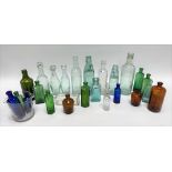 A collection of vintage advertising and other glass bottles.