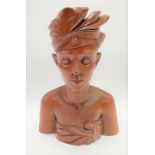 A large Balinese carved wood bust, signed A. Fatimah to the base, height 33.5cm.