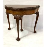 An 18th century style burr walnut veneered demi-lune card table, the shaped top with moulded and