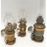 A pair of brass gimballed ships wall lamps, with glass shades, height 19cm, together with another