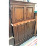 A 19th century mahogany two section hall cupboard, the top with fielded panelled cupboard doors