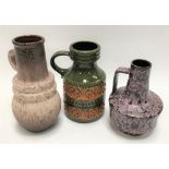 Three West German pottery vases with loop handles, the tallest 27cm.