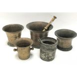 Four antique brass mortars, together with a pestle and an eastern silvered copper swing handled