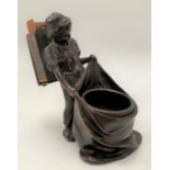 A bronzed spelter figural matchbox holder in the form of a boy holding a sack, height 14cm.