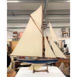 An early 20th century impressive and large pond yacht upon stand, height 204cm, width 182cm.