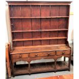 Good 18th Century oak and pine dresser, the tall raised back with a moulded cornice over three fixed