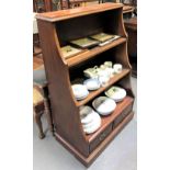 A mahogany inlaid waterfall bookcase with two fixed shelves over two drawers and on a plinth base,