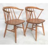 A pair of Ercol pale elm and beech carver chairs.