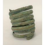 Viking bronze coiled arm bracelet with zigzag and wriggle work design, height 7.5cm.