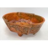 A 19th Century Chinese archaic earthenware ochre and green glazed censer raised on four feet and