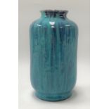 A Ruskin style high fired glazed cylindrical vase with pale blue and dark blue drip glaze, height
