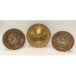 A pair of Indian brass, copper and white metal applied embossed circular dishes, the wells both