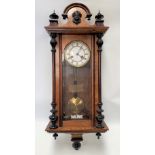 A Junghams two-train Vienna wall clock with walnut case, height including surmount 83cm