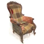 A Victorian mahogany framed gentlemans salon chair, the back with foliate scroll carved and