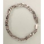 A good 18ct white gold diamond set curb link bracelet, the thirteen diamonds each of 0.05ct spread