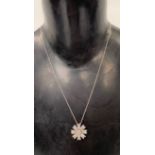 A good white metal, possibly platinum diamond set flower pendant, upon 18ct white gold fine chain,